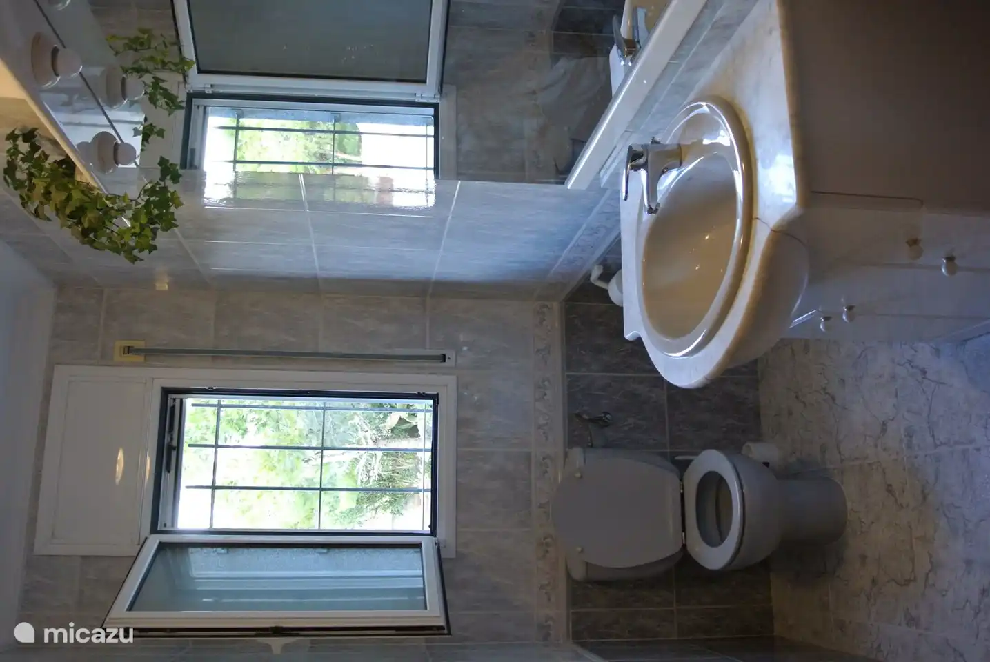 Badezimmer 2. Dieses zweite Badezimmer von Wohnung 1 hat eine Toilette und ein Waschbecken