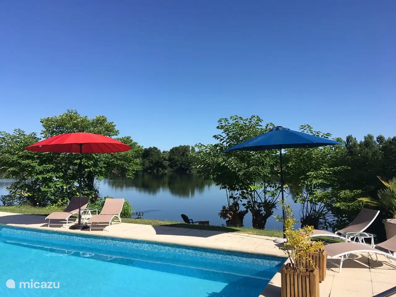 The swimming pool with sun loungers and parasols