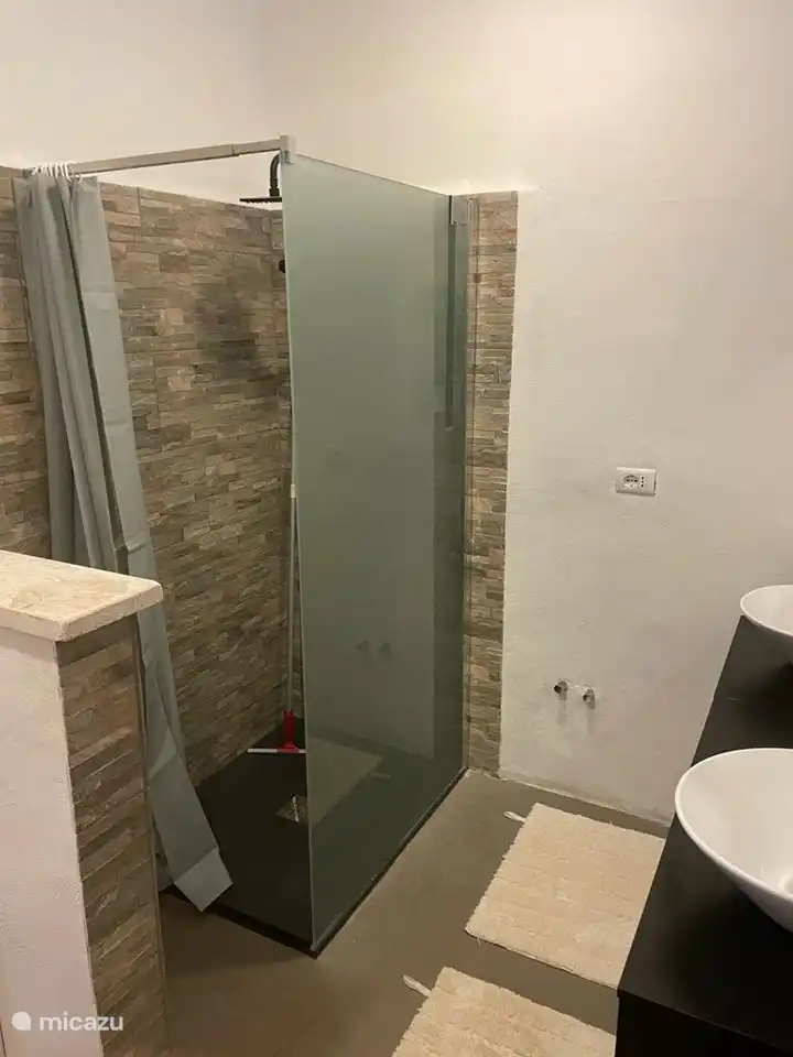 Badezimmer mit ebenerdiger Dusche und Doppelwaschbecken, das zu 2 Zimmern im Erdgeschoss gehört