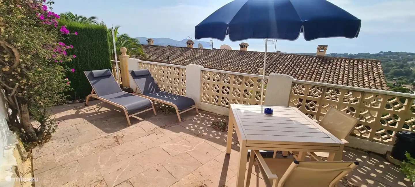 Die untere Terrasse mit Sonnenliegen, Sonnenschirm, Stühlen, ausziehbarem Esstisch und Grill. Schöner Meerblick.