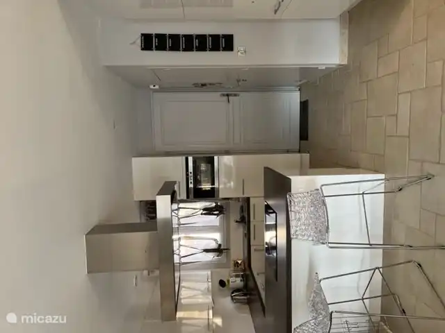 La cuisine spacieuse (en forme de U) avec bar.