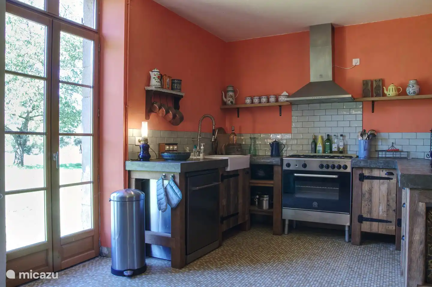 Die Küche mit Geschirrspüler. Es gibt auch eine Waschmaschine und einen Trockner in der Küche. Der Hinterhof ist durch die Tür sichtbar.