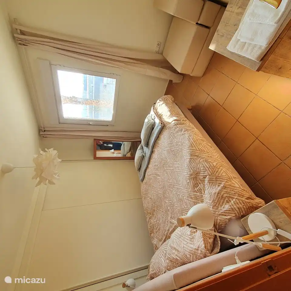 master bedroom with window and roller blind and air conditioning and wardrobe