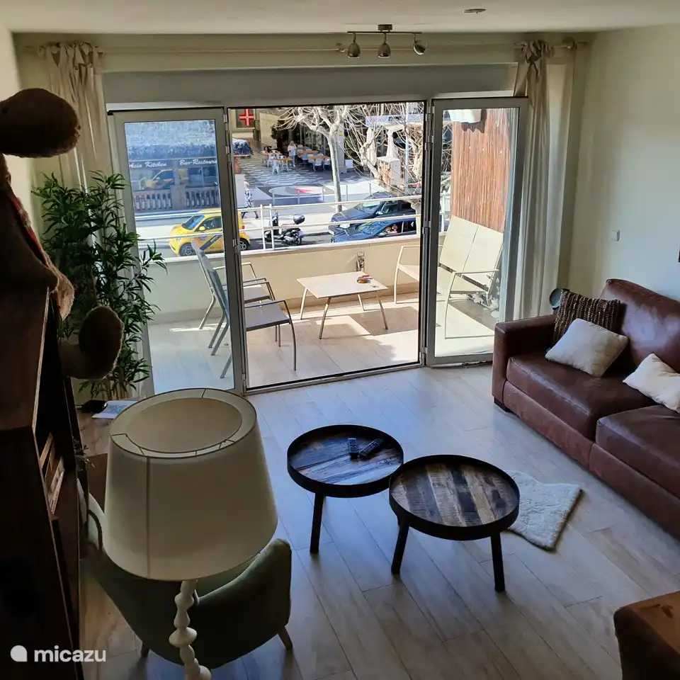 living room with patio doors and large terrace with garden furniture etc.