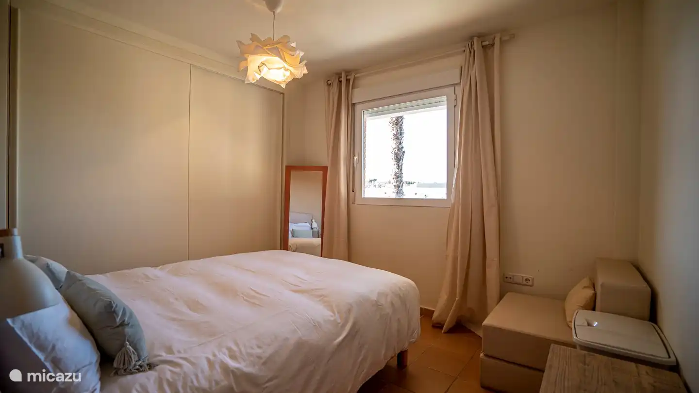 master bedroom with many cupboards and spare linen and air conditioning