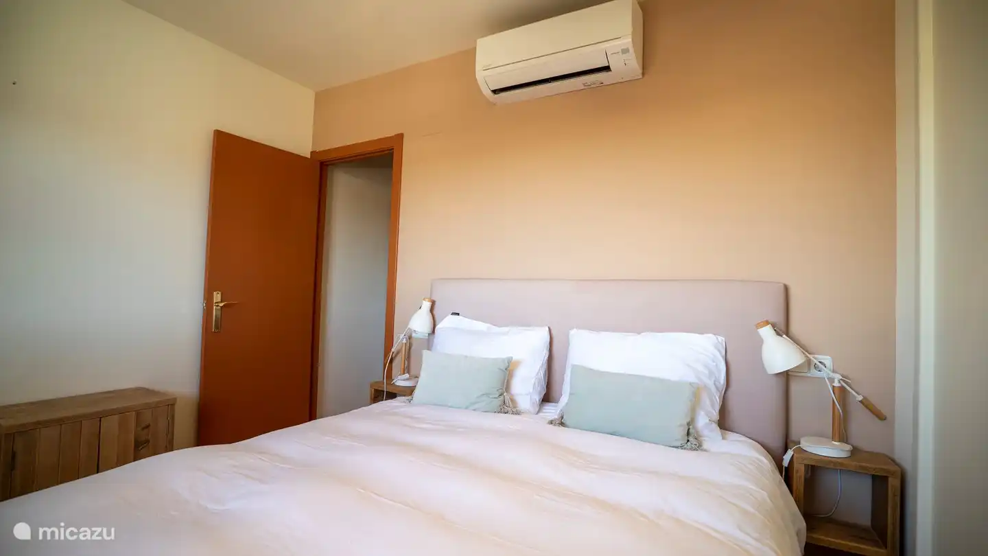 master bedroom with door to hall/bathroom/towards 2nd bedroom and air conditioning