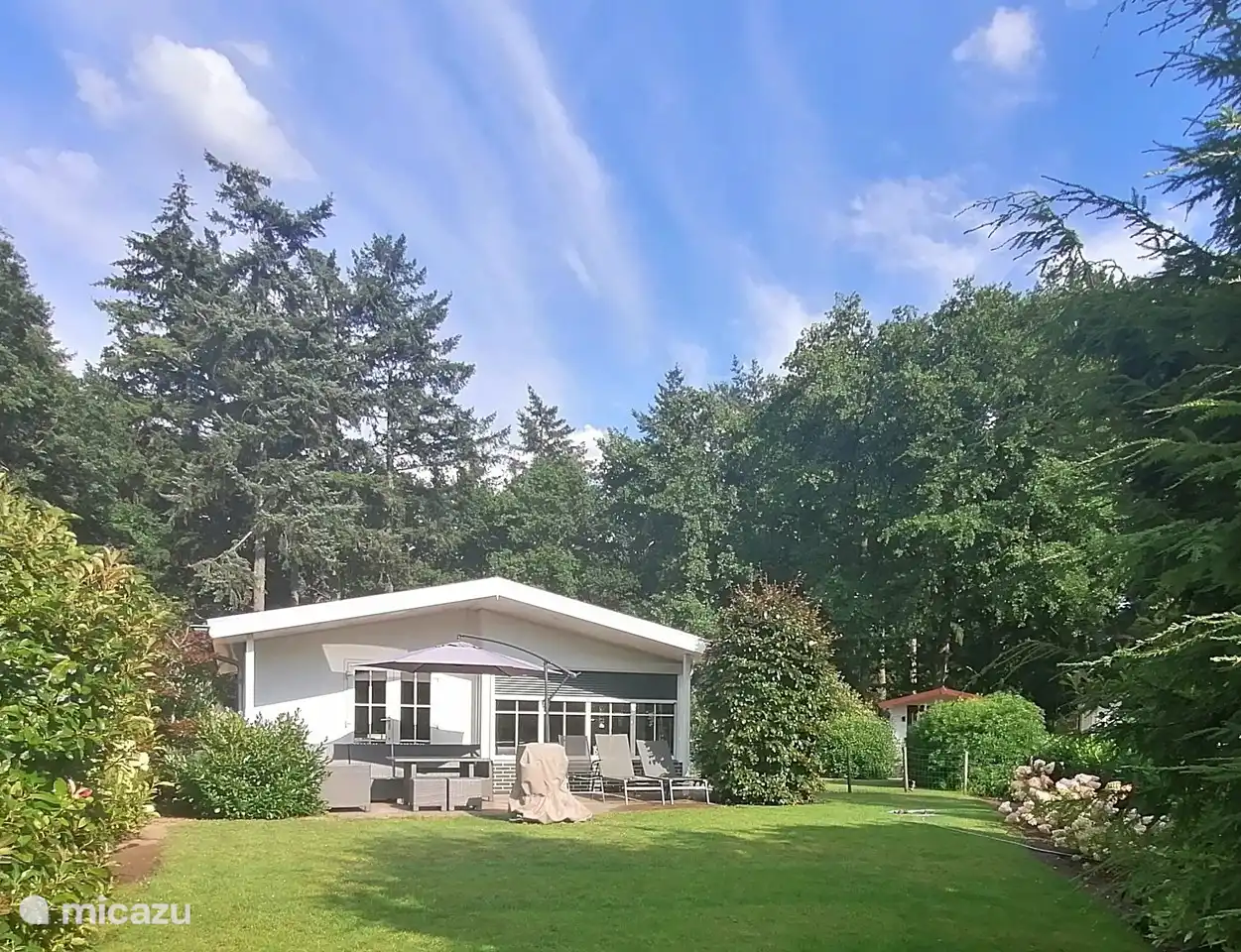 The spacious garden with lots of privacy and several sitting areas