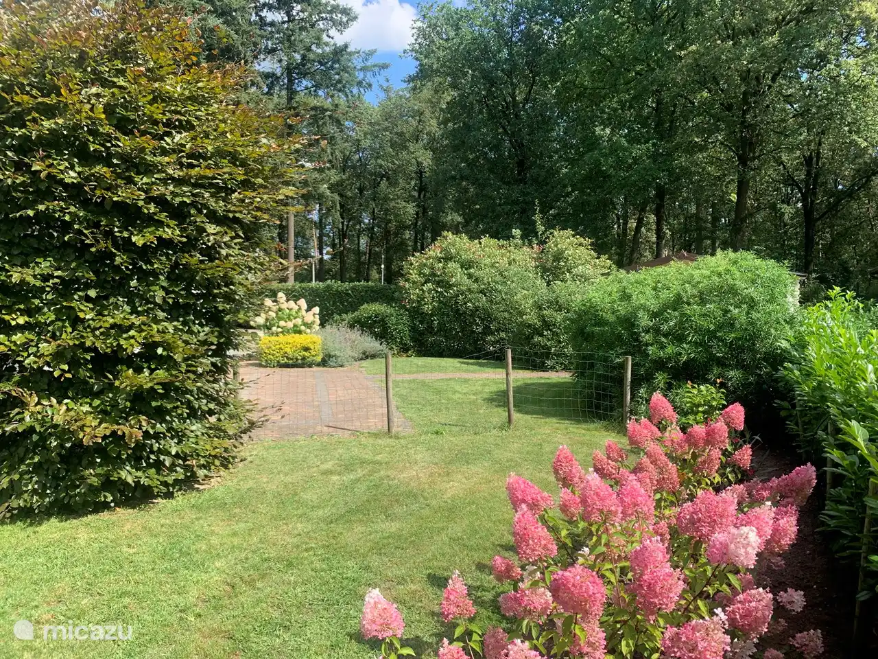 The spacious garden with lots of privacy and several sitting areas