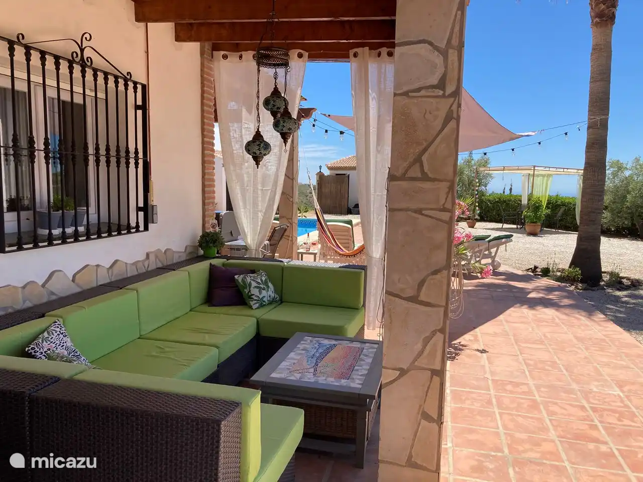 There is a lounge set under the veranda. Comfortable lounging, but not in full sun.