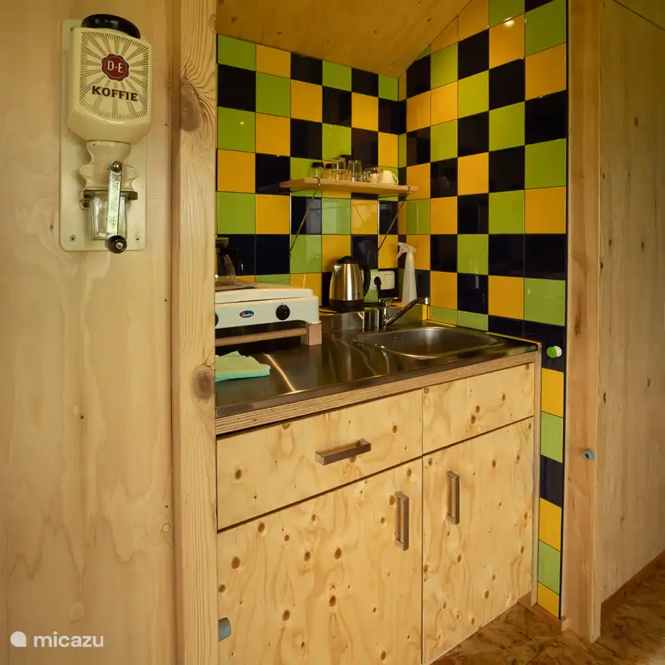simple kitchen with fridge. crockery, cutlery, pots and pans. exactly what you need.