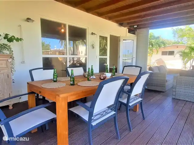 Villa de lujo con hermoso jardín en Aruba, Paradera, Paradera - villa Veranda con jacuzzi, mesa de comedor y juego de salón.