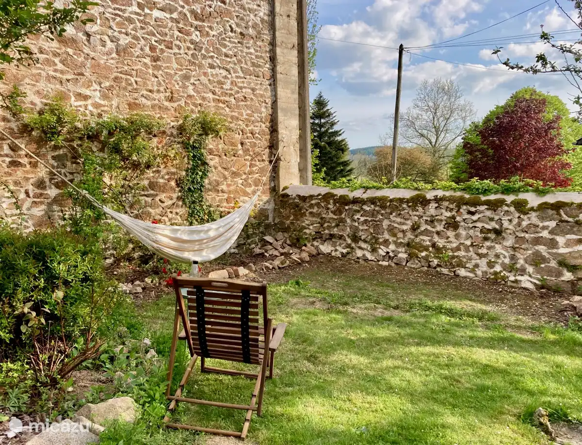In the shade of the apple tree and sheltered from the small road.