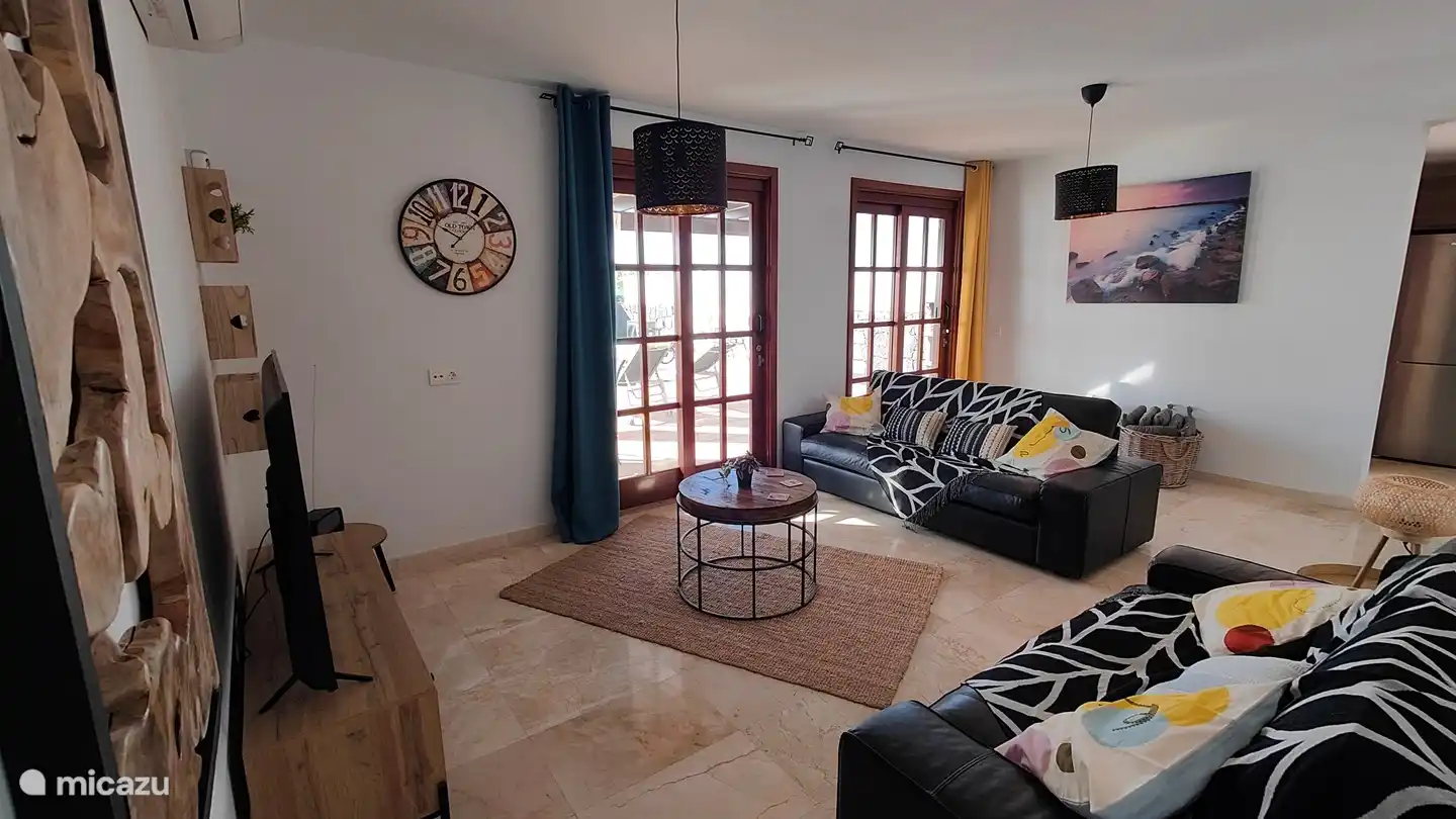 The spacious and cozy lounge overlooking the terrace and swimming pool.