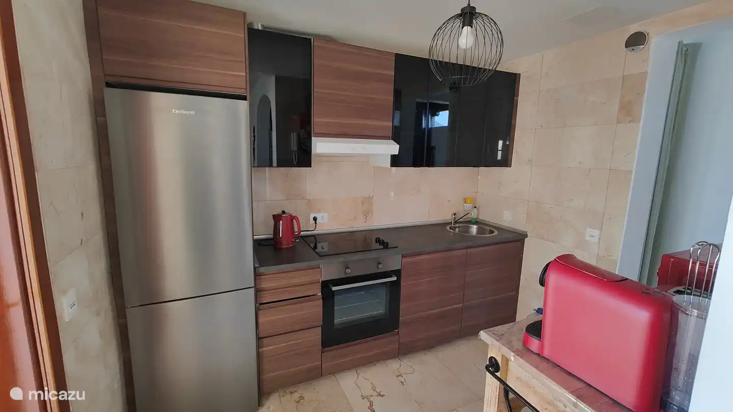 The fully equipped kitchen with fridge/freezer, dishwasher, kettle, toaster, oven, microwave and capsule coffee machine