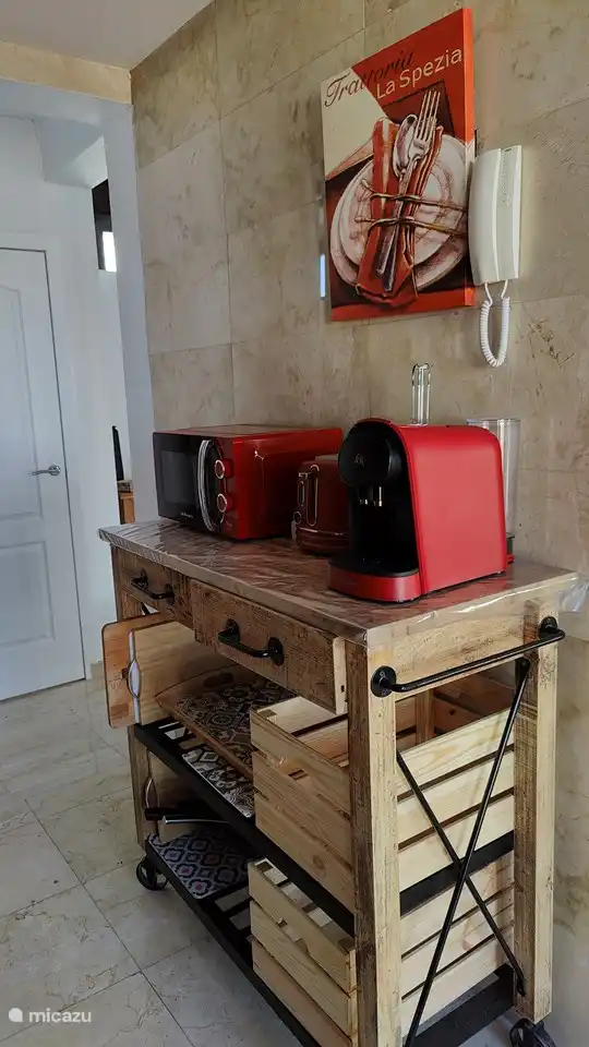 Island with kitchen appliances and storage options