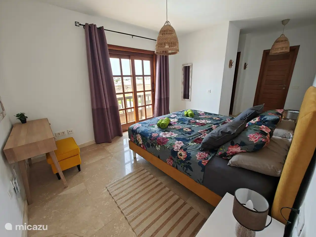 Master bedroom with a view of the pool
