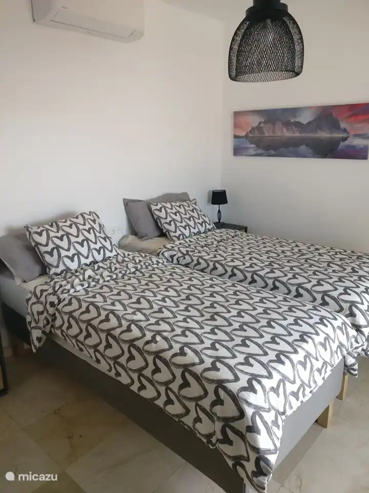 Twin bedroom ground floor overlooking the spacious terrace and swimming pool