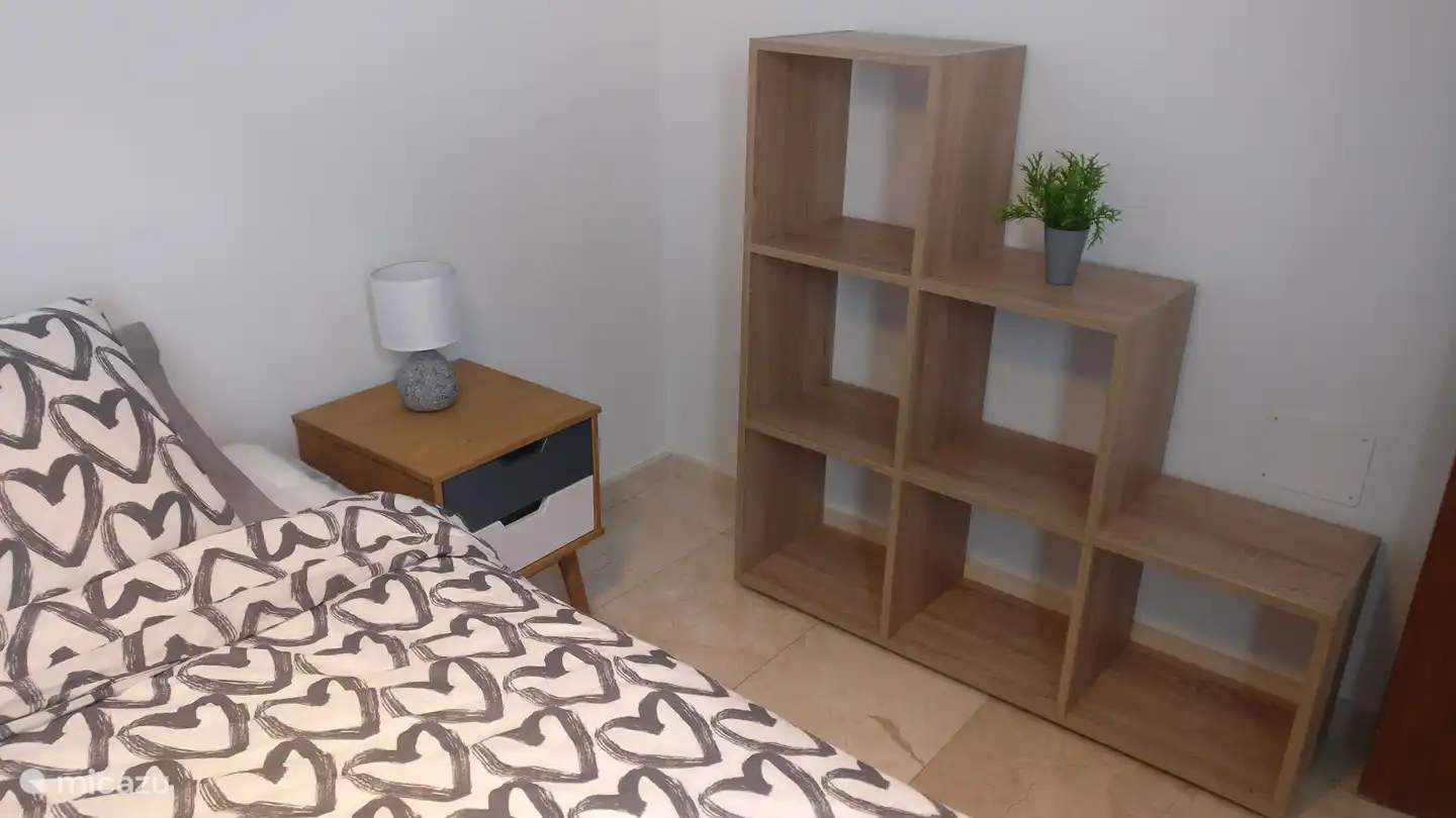 Twin bedroom on -1 with a view of an enclosed terrace