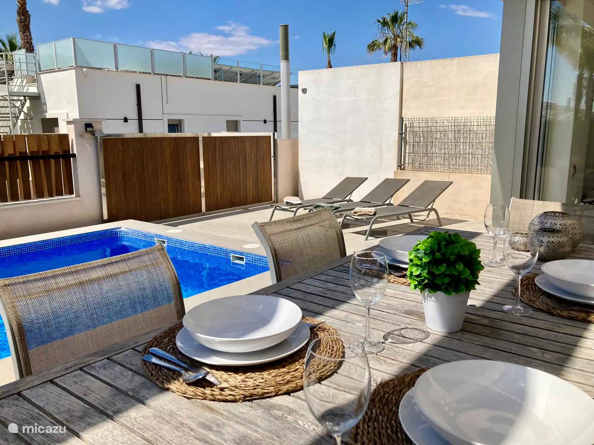 Cozy outdoor dining together right next to the pool