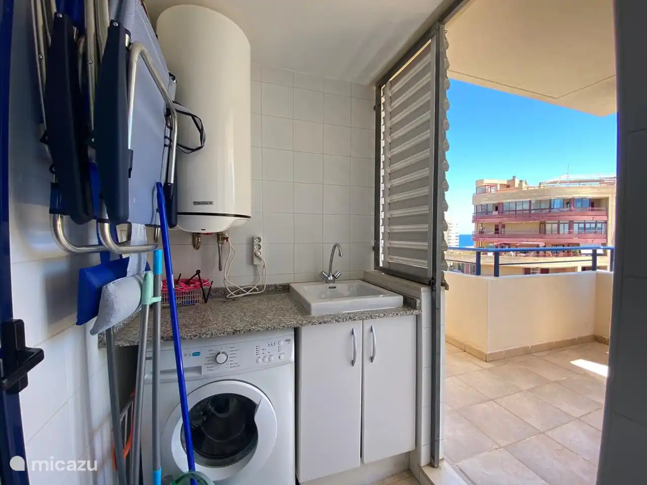 The utility room with washing machine