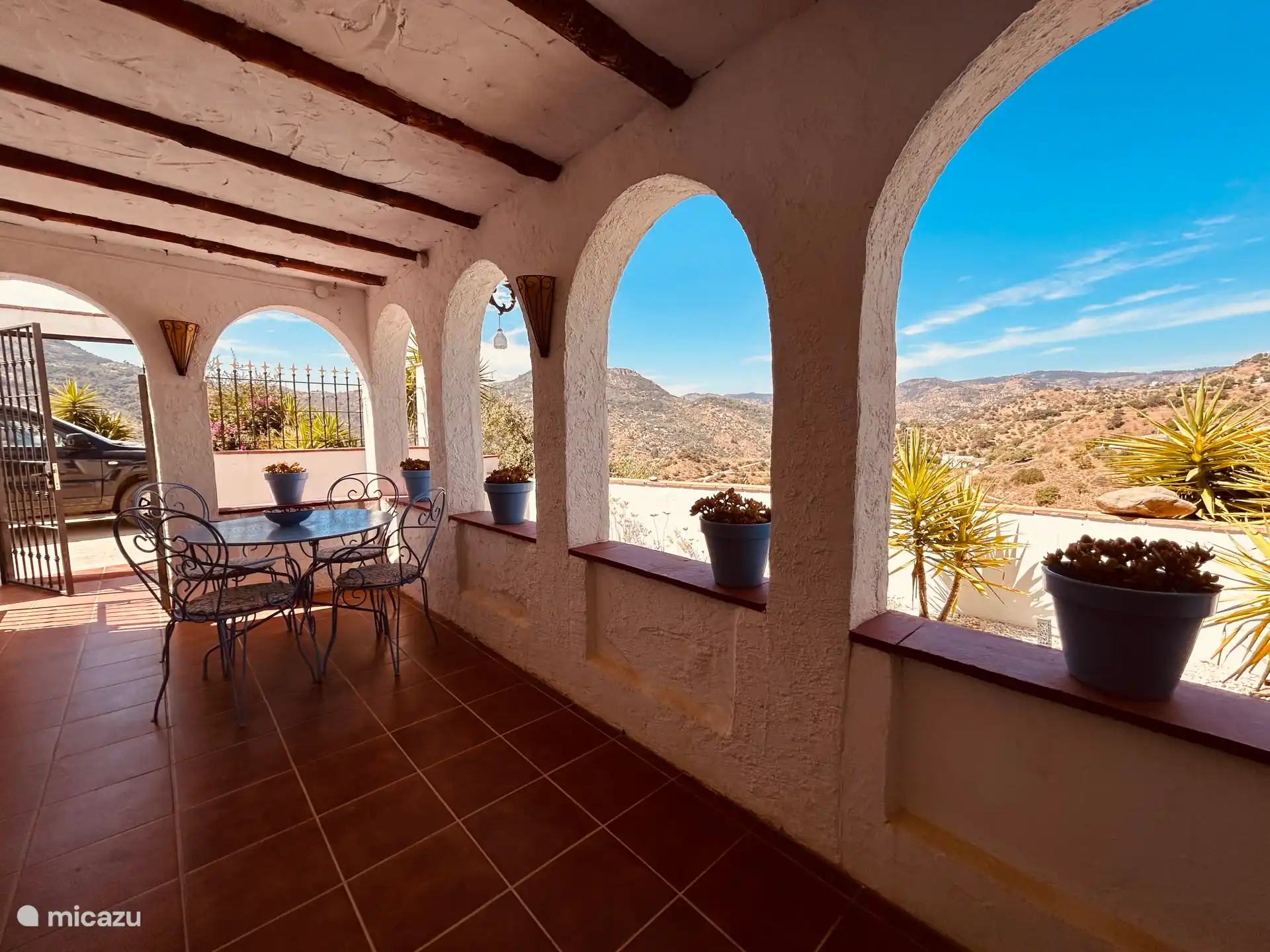 Overdekt terras met vrij uitzicht over de bergen.