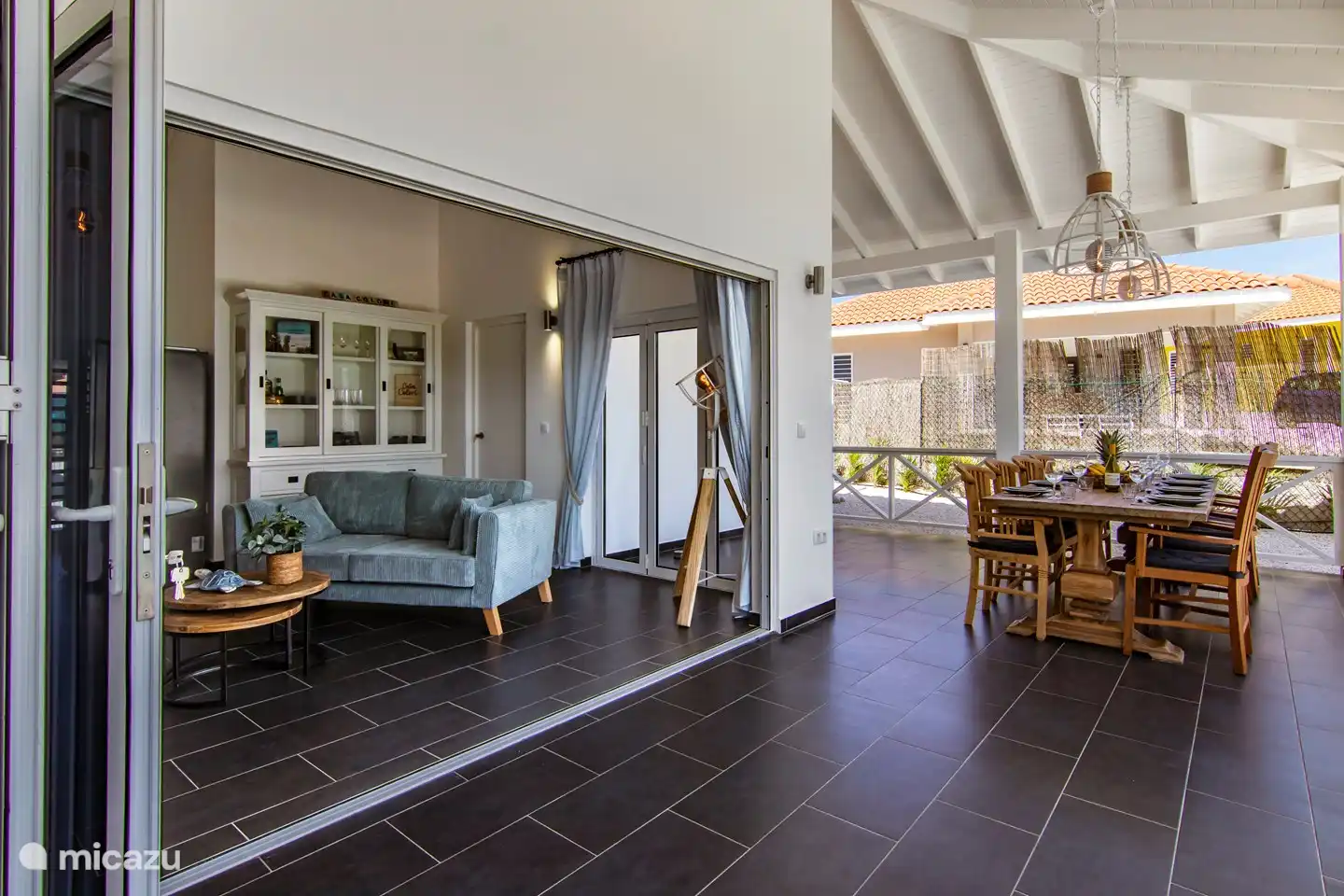 Salón comedor desde el porche con gran puerta abatible