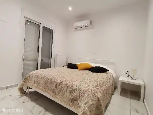 spacious bedroom with air conditioning and large linen closets