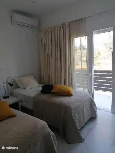 2 single beds with a view of Mount Milo and a private terrace for your morning coffee