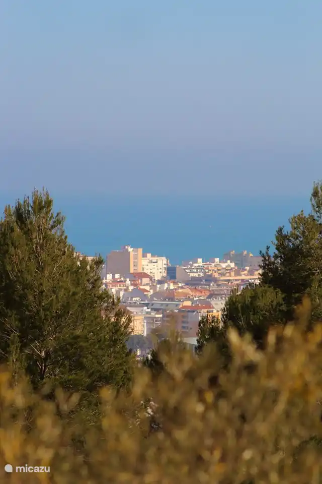 The view from the naya on the Mediterranean Sea, Dénía city and Castillo de Dénía, beautifully lit at night. (1/2)