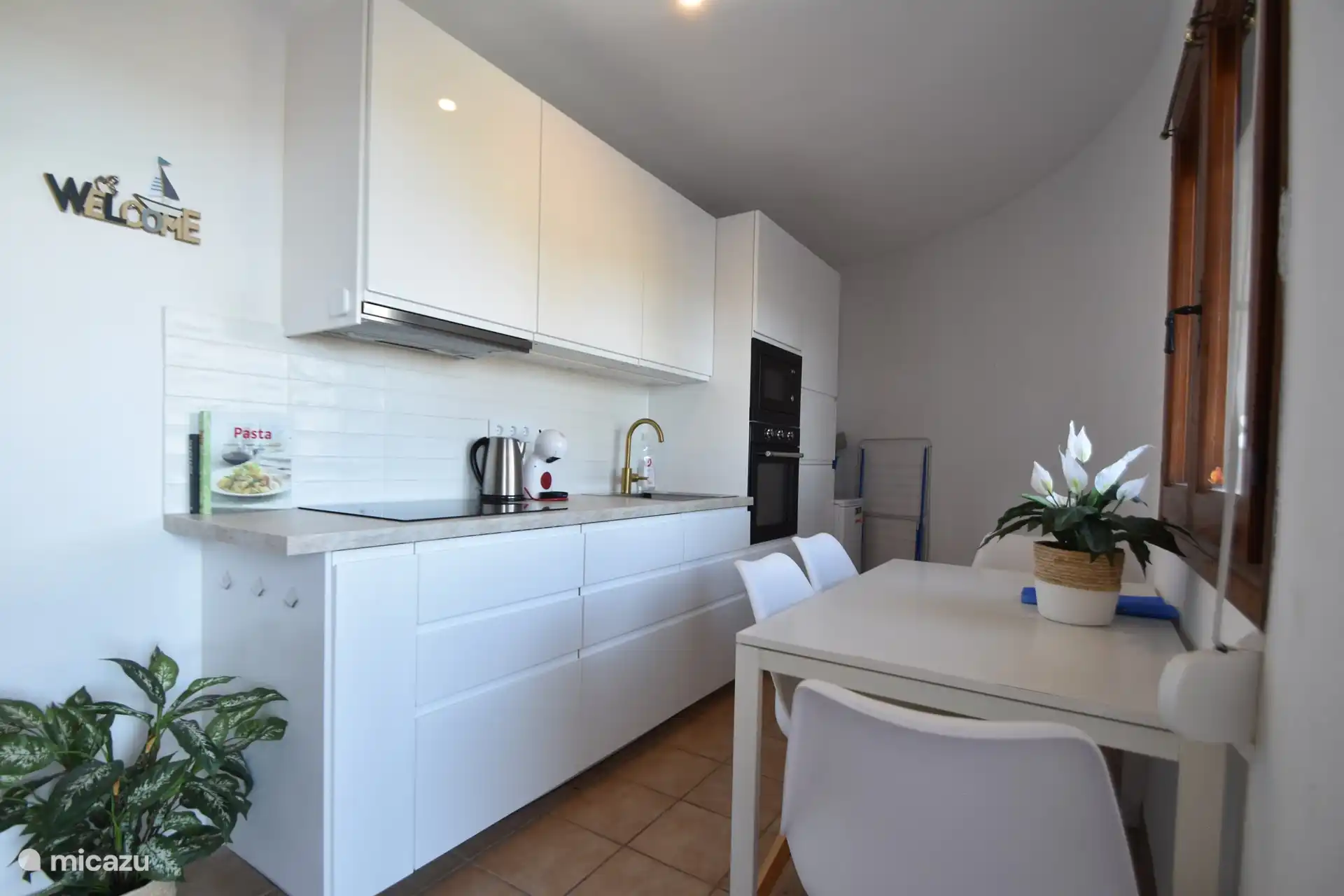 Renovierte Küche mit Geschirrspüler, Mikrowelle und Heißluftofen. Großer Einbaukühlschrank mit Gefrierfach. Die Küche öffnet sich unten direkt auf die Sonnenterrasse.