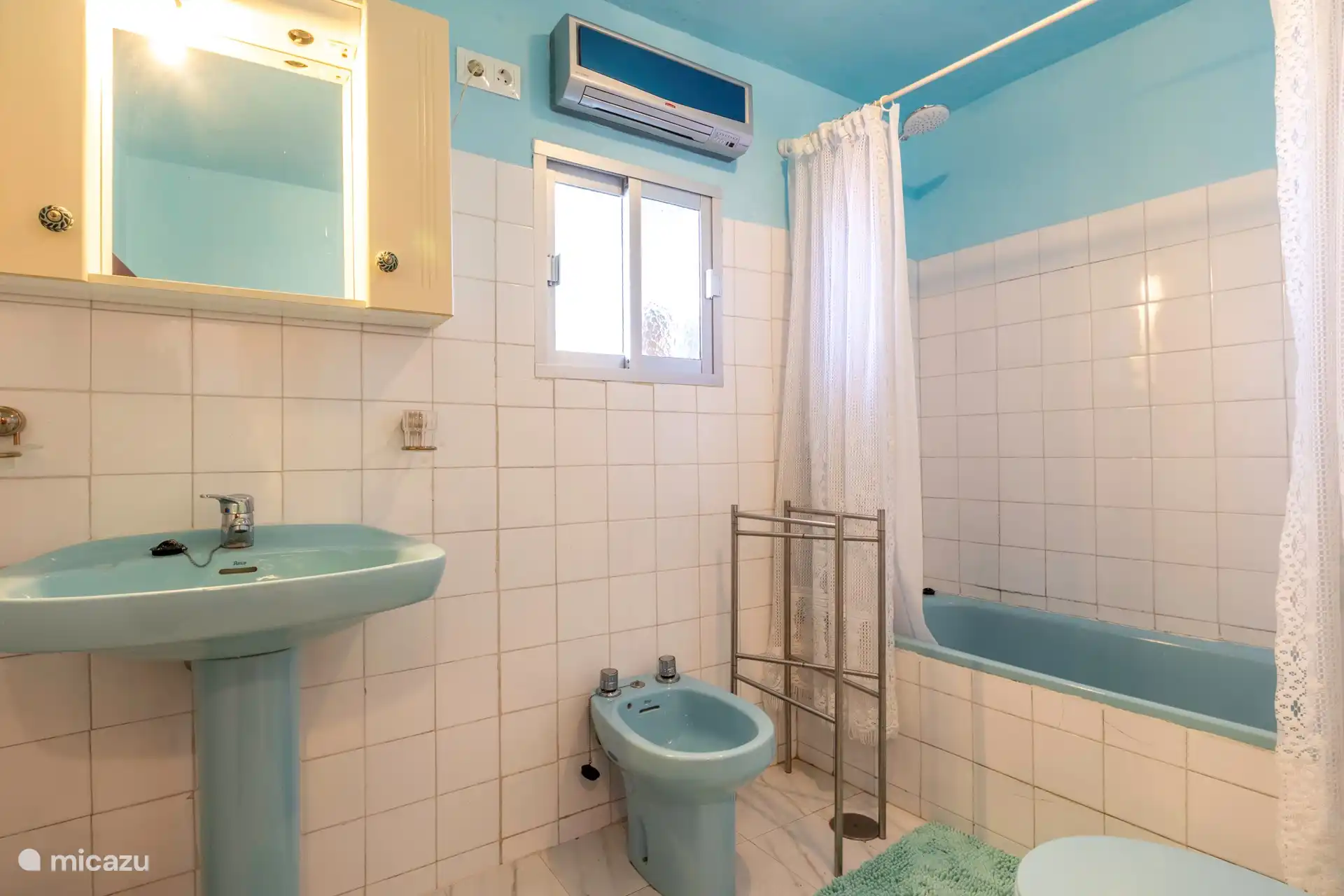 Authentic bathroom with shower, bath, bidet and toilet.