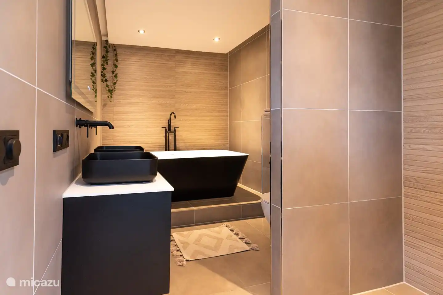 Luxuriöses Badezimmer mit Fußbodenheizung, WC, Badewanne, Dusche und Doppelwaschbecken