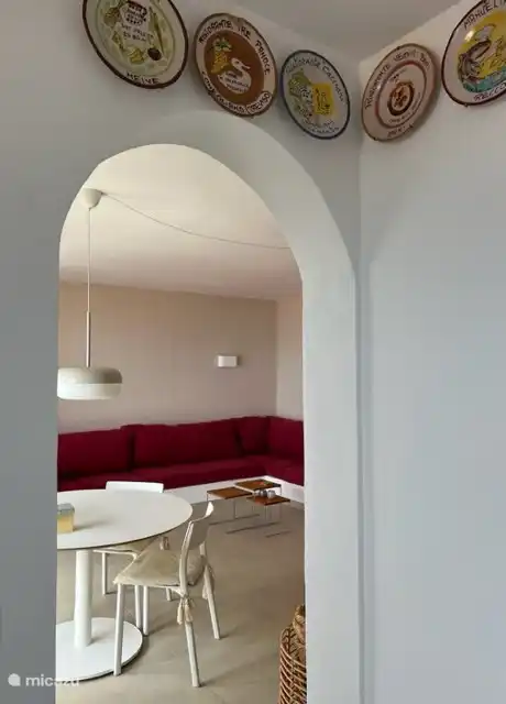 View from the kitchen to the dining table inside and living room.