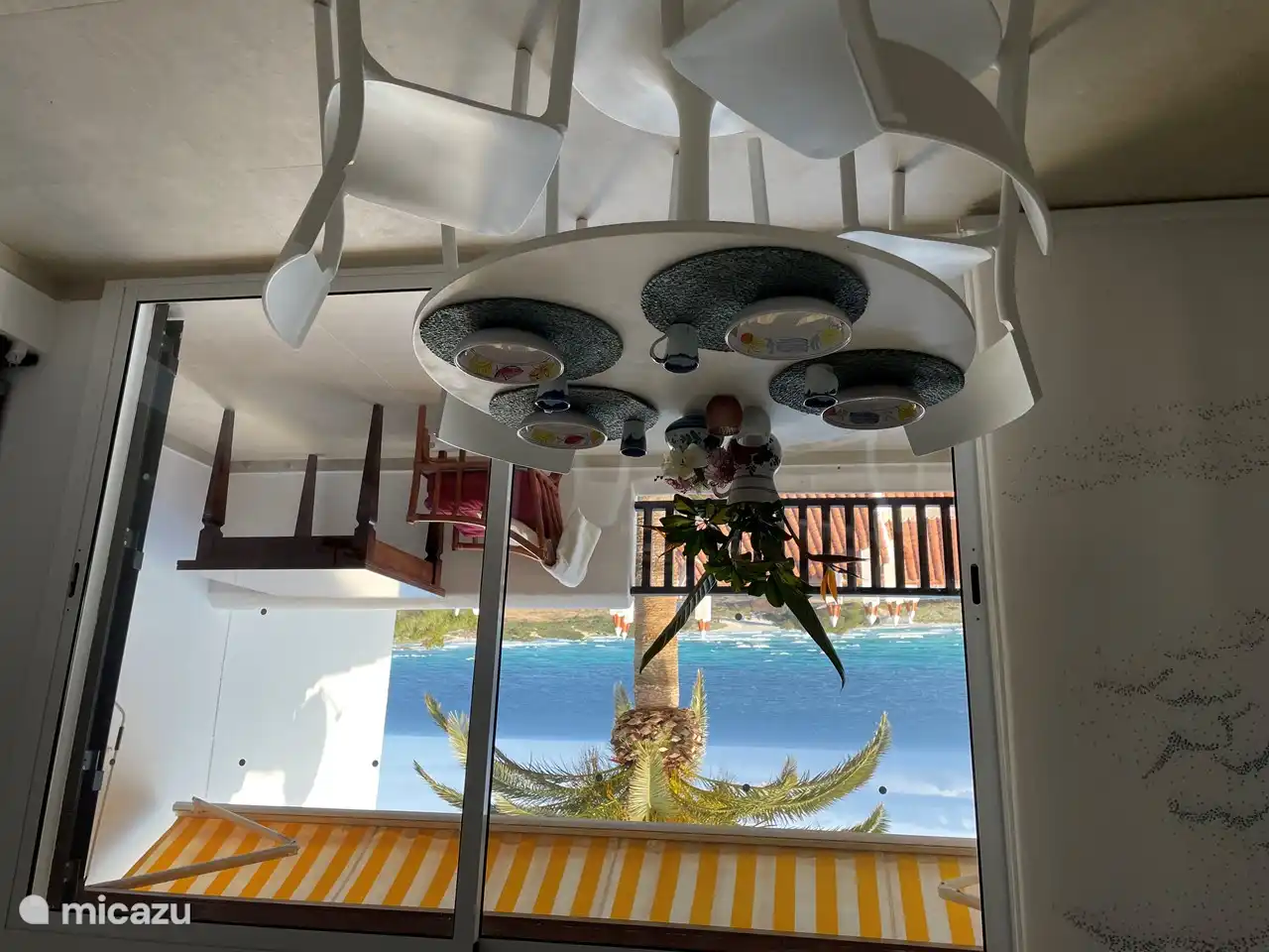 Inside, a nice dining area has been created with a round table. From the table, the view of the sea is fantastic.