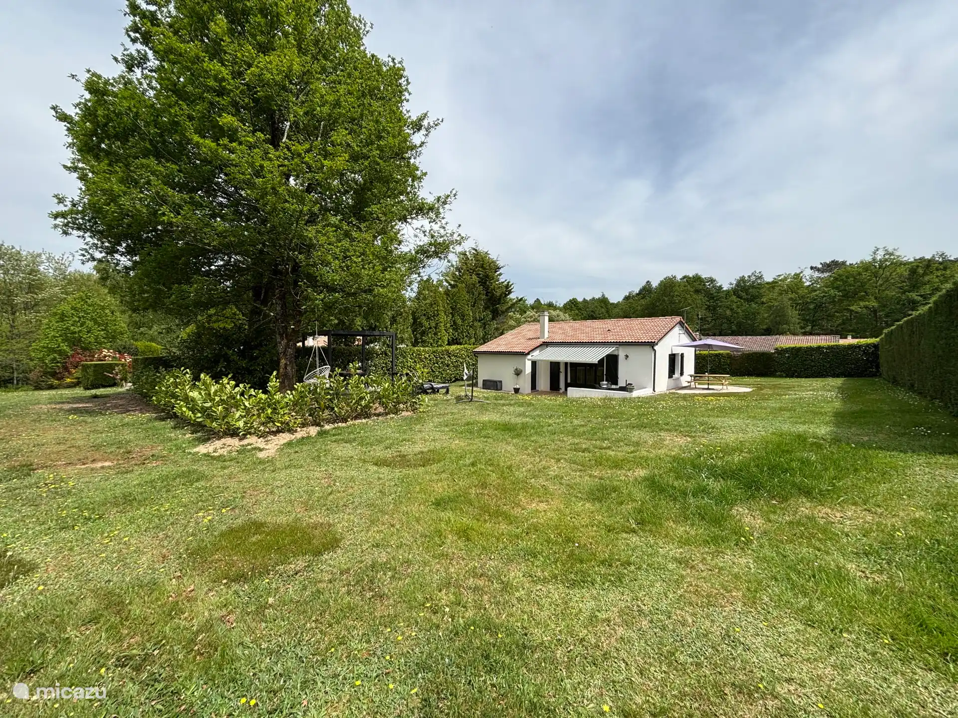 Rear of the house with two terraces, 3rd terrace is shaded under the trees