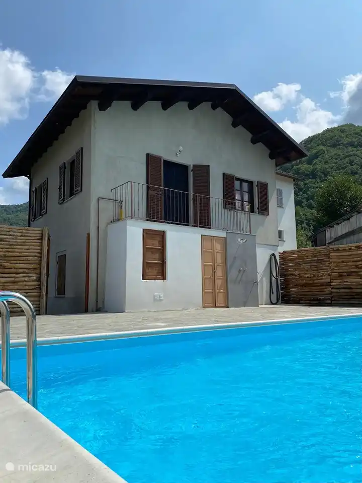 The heated swimming pool with sauna and hot tub.