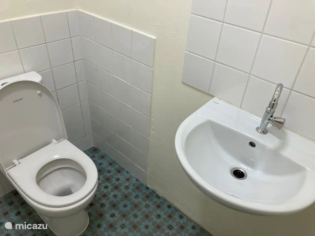 Separater Toilettenraum mit Waschbecken im Badezimmer.