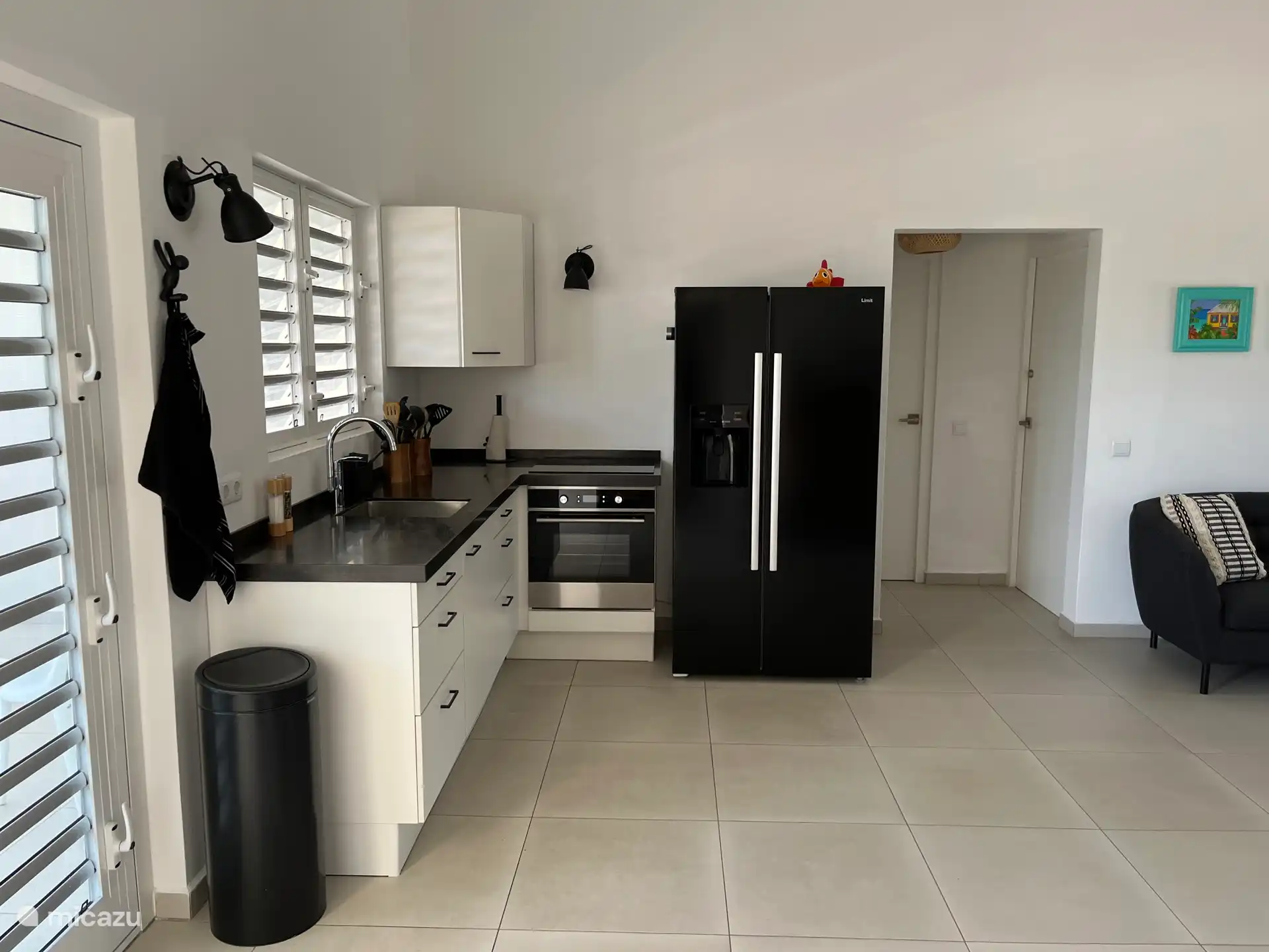 Küche mit Backofen, Induktionskochfeld und amerikanischem Kühlschrank.