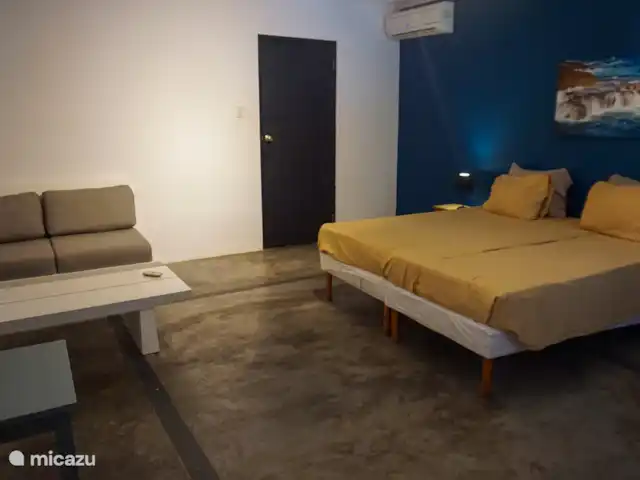 Apartment Jeremi with pool in Curaçao, Curacao-Middle, Julianadorp - bed & breakfast Large bedroom with sofa and wardrobe
