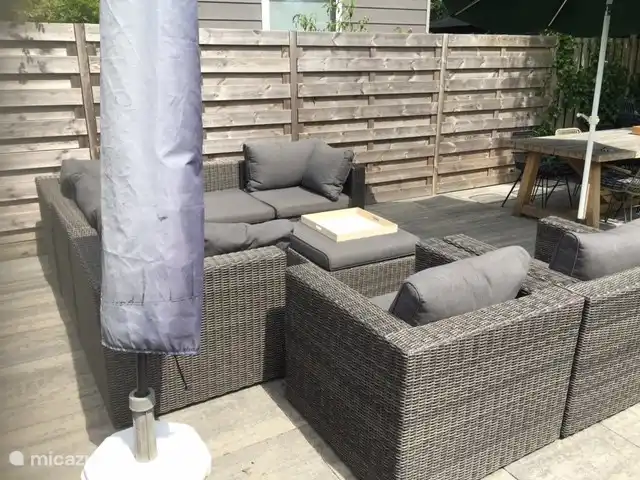 Terraza con juego de salón y sombrillas.