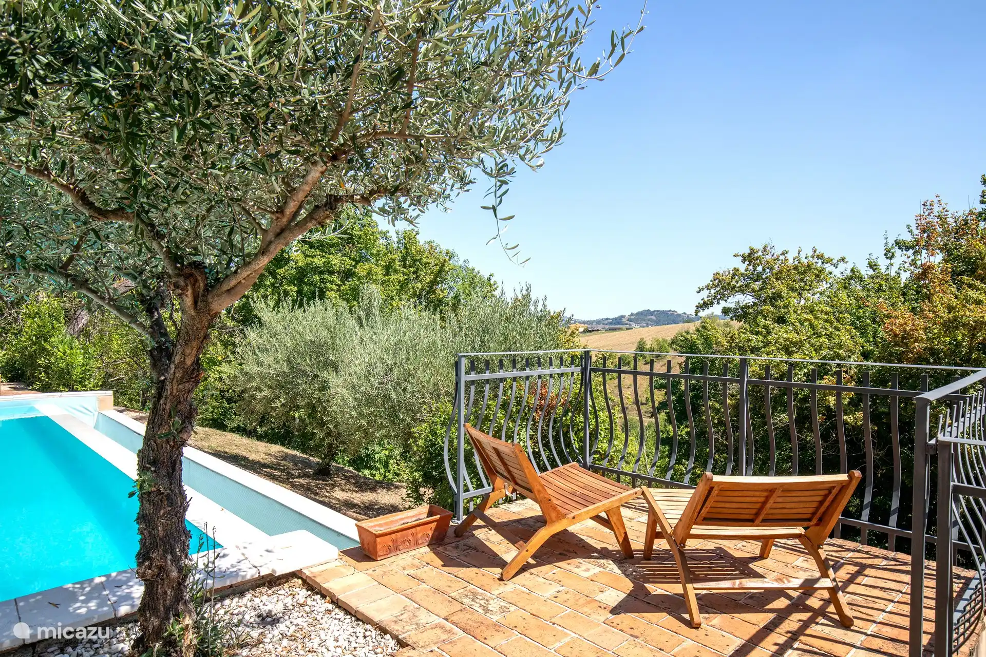 Auf diesem Foto sehen Sie eine Ecke des Pools mit zwei Stühlen und einem Tisch, um Ihr Lieblingsgetränk zu genießen und gleichzeitig den Panoramablick zu genießen.