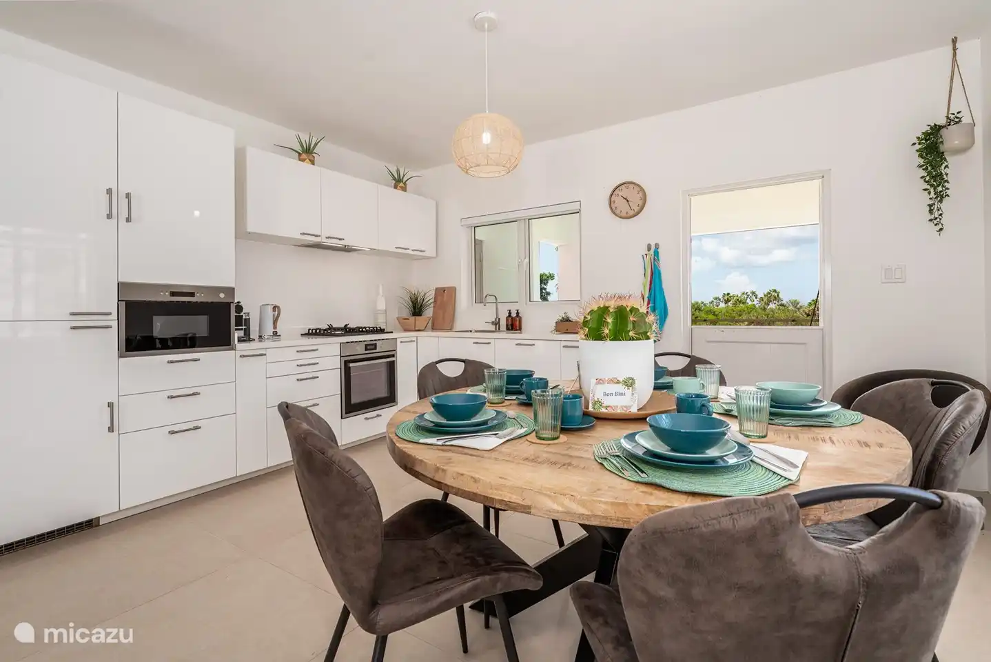 Dining table and fully equipped kitchen.