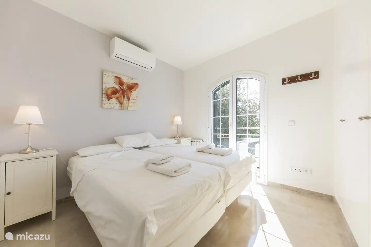 bedroom 2/3 with air conditioning and patio doors to a balcony