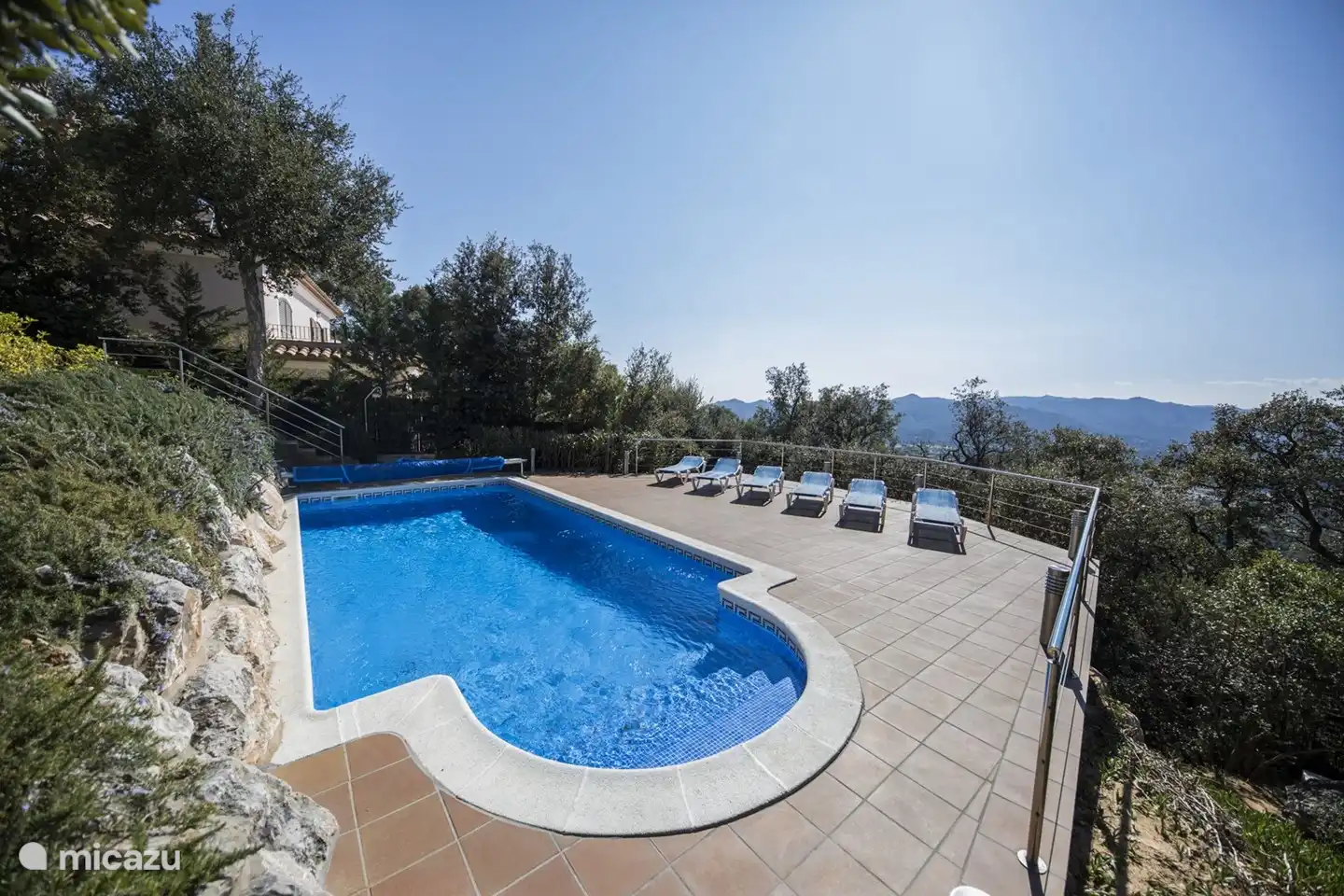 lovely swimming pool with round entry side with large terrace for sunbathing.