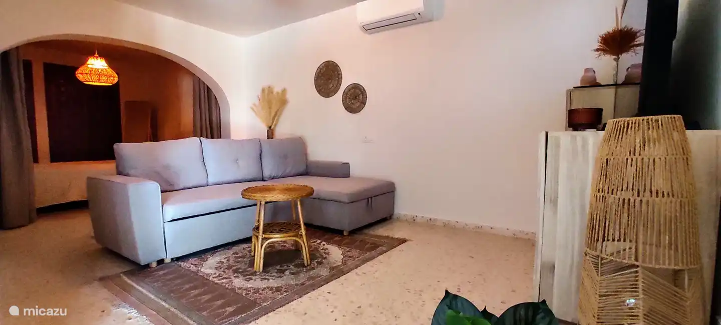 Wohnzimmer im Erdgeschoss mit Schlafzimmer (durch Vorhang getrennt)