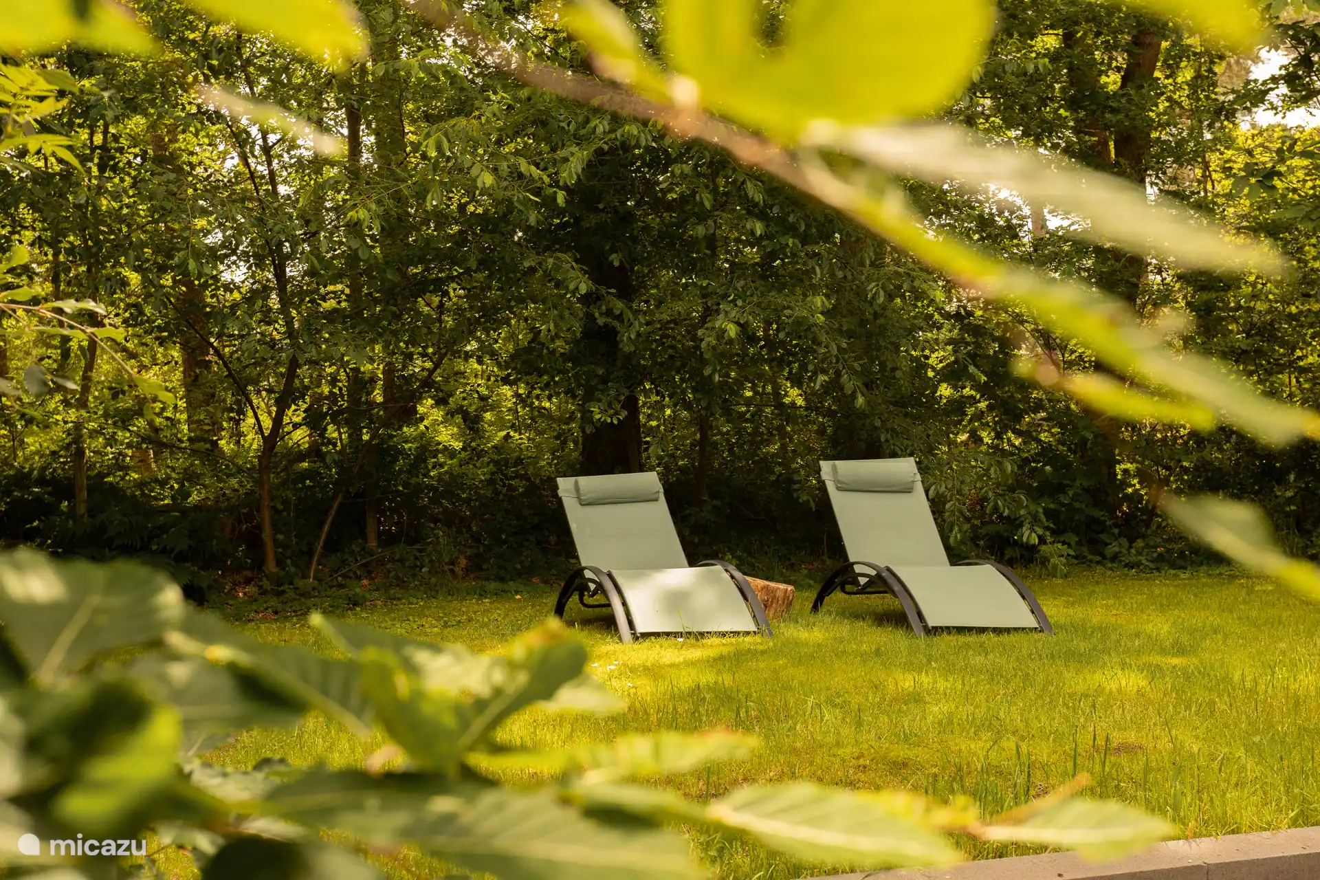 Auf einer erhöhten Rasenfläche befinden sich diese beiden Liegestühle abseits des Trubels.