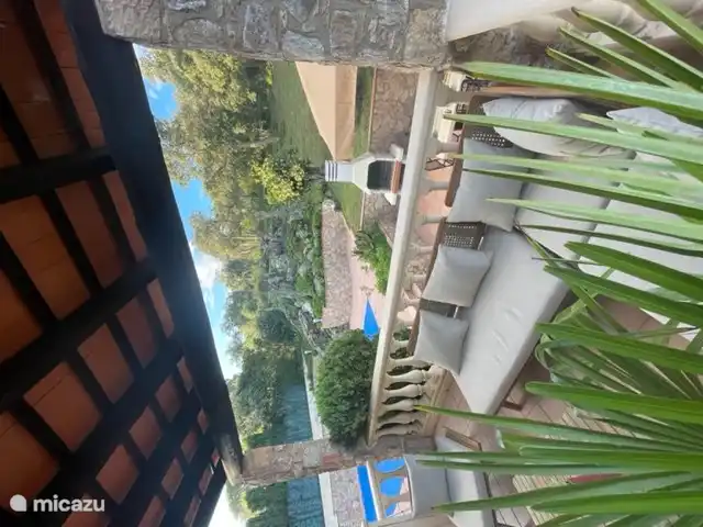Terrace on veranda overlooking the garden and pool