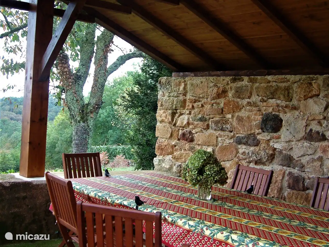 covered terrace with large dining table and BBQ