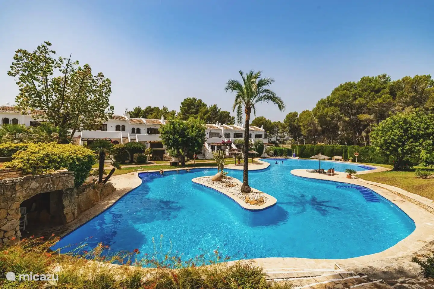 The large communal swimming pool (with island, waterfall, various depths and separate children's pool). Hours of water fun guaranteed!