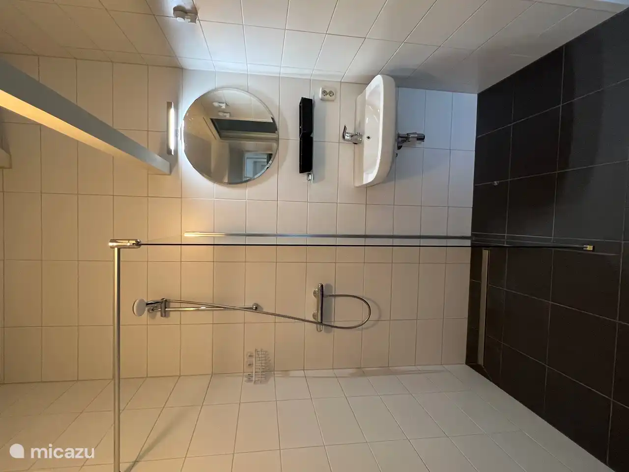 Completely new bathroom with a spacious shower with mirror and sink